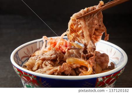 Beef bowl picked up with chopsticks 137120182