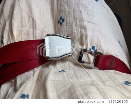 Aircraft seat belt opened on passenger seat. Inflight readiness, movement freedom, and cabin transition through aviation safety equipment Aircraft seat belt opened on passenger seat. Inflight readiness, movement freedom, and cabin transition through aviation safety equipment 137120195
