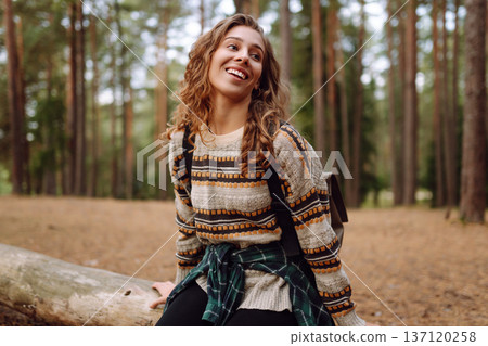 Tourist woman hiking alone in natural forest. Active lifestyle. People in forest. Nature, travel Tourist woman hiking alone in natural forest. Active lifestyle. People in forest. Nature, travel 137120258