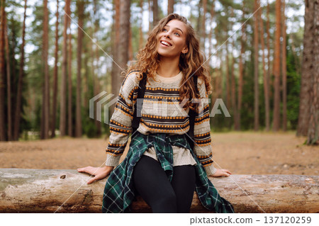 Tourist woman hiking alone in natural forest. Active lifestyle. People in forest. Nature, travel Tourist woman hiking alone in natural forest. Active lifestyle. People in forest. Nature, travel 137120259
