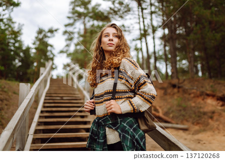 Attractive young woman enjoying fresh air on the lake. Travel, Hiking, nature Attractive young woman enjoying fresh air on the lake. Travel, Hiking, nature 137120268