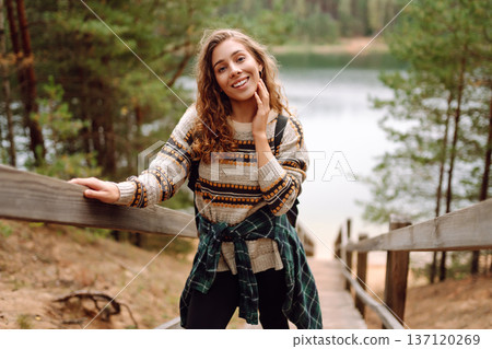 Attractive young woman enjoying fresh air on the lake. Travel, Hiking, nature Attractive young woman enjoying fresh air on the lake. Travel, Hiking, nature 137120269