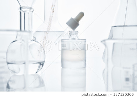 Skincare serum bottle and laboratory glassware in research Skincare serum bottle and laboratory glassware in research 137120306