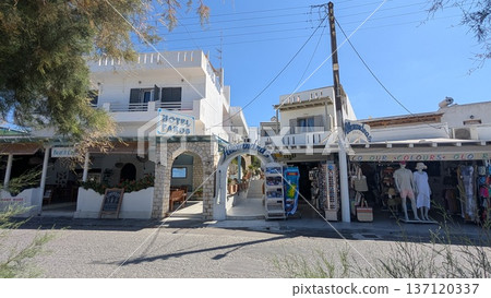 Townscape of the touristic area with hotel, restaurant, souvenir shop along with the beach under the clear blue sky 137120337