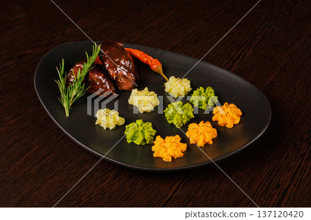 Fried meat on a plate with different sauces and 137120420