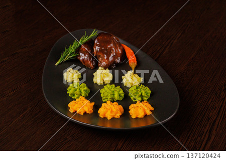 Fried meat on a plate with different sauces and 137120424