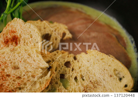 Cream soup with pieces of beef and herbs 137120448