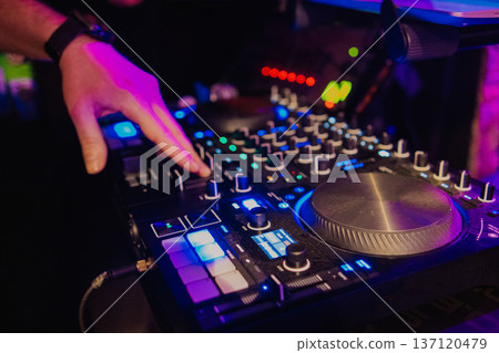 A DJ booth in the evening lights of a club A DJ booth in the evening lights of a club 137120479