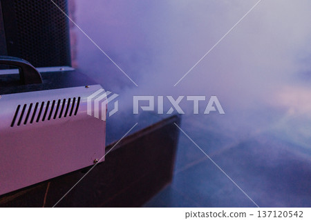 Smoke comes out of a smoke machine at a restaurant 137120542