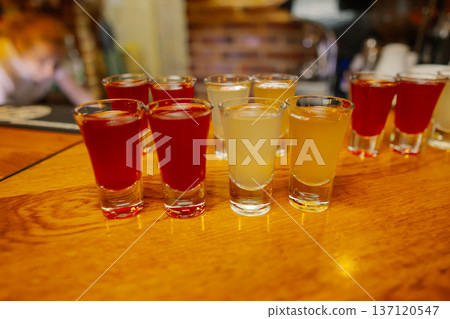 Liqueurs of different colors in shot glasses Liqueurs of different colors in shot glasses 137120547