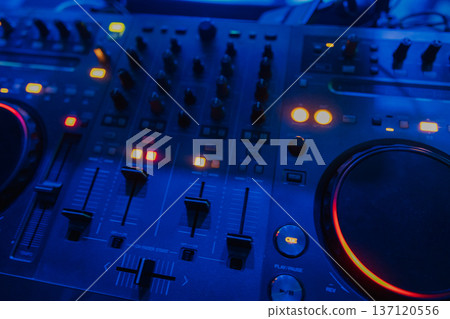 A DJ booth in the evening lights of a club A DJ booth in the evening lights of a club 137120556
