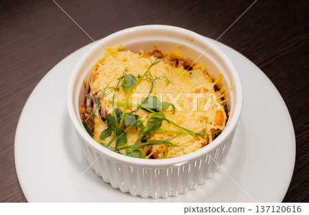 Onion soup in a white bowl looks delicious, with Onion soup in a white bowl looks delicious, with 137120616