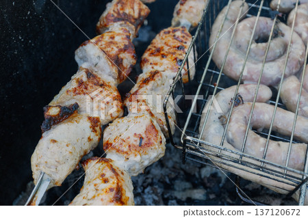 Kebabs and sausages are being grilled on the grill Kebabs and sausages are being grilled on the grill 137120672