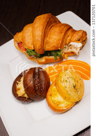 Croissant with salmon and stuffed buns on a plate Croissant with salmon and stuffed buns on a plate 137120701