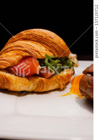 Croissant with salmon and stuffed buns on a plate 137120712