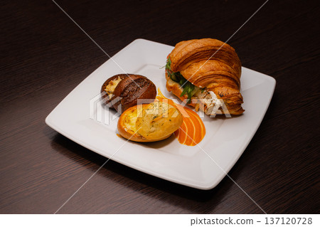 Croissant with salmon and stuffed buns on a plate Croissant with salmon and stuffed buns on a plate 137120728