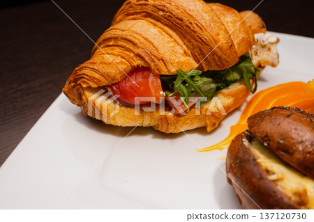 Croissant with salmon and stuffed buns on a plate Croissant with salmon and stuffed buns on a plate 137120730