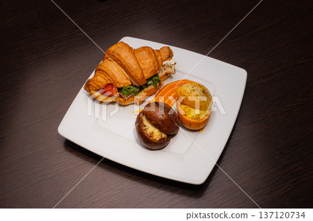 Croissant with salmon and stuffed buns on a plate Croissant with salmon and stuffed buns on a plate 137120734