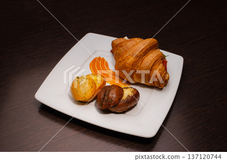 Croissant with salmon and stuffed buns on a plate Croissant with salmon and stuffed buns on a plate 137120744
