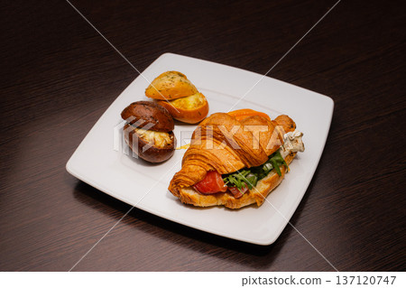 Croissant with salmon and stuffed buns on a plate Croissant with salmon and stuffed buns on a plate 137120747