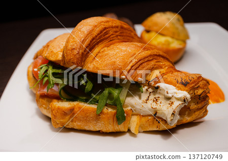 Croissant with salmon and stuffed buns on a plate Croissant with salmon and stuffed buns on a plate 137120749