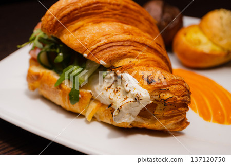 Croissant with salmon and stuffed buns on a plate Croissant with salmon and stuffed buns on a plate 137120750