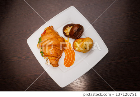Croissant with salmon and stuffed buns on a plate 137120751