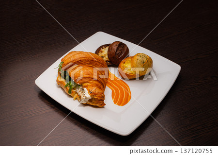 Croissant with salmon and stuffed buns on a plate Croissant with salmon and stuffed buns on a plate 137120755