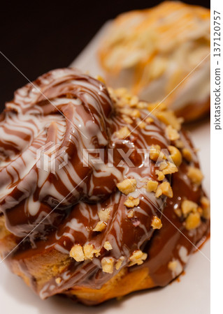 Cinnabon on a white plate and on a wooden table Cinnabon on a white plate and on a wooden table 137120757