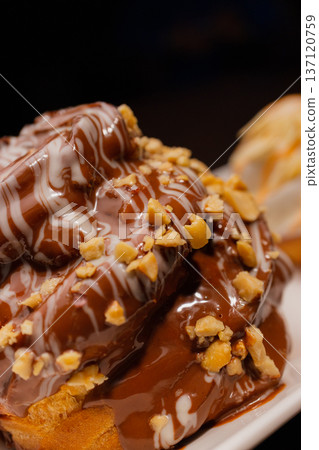 Cinnabon on a white plate and on a wooden table 137120759