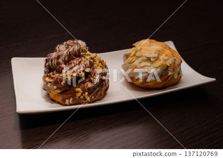Cinnabon on a white plate and on a wooden table 137120769