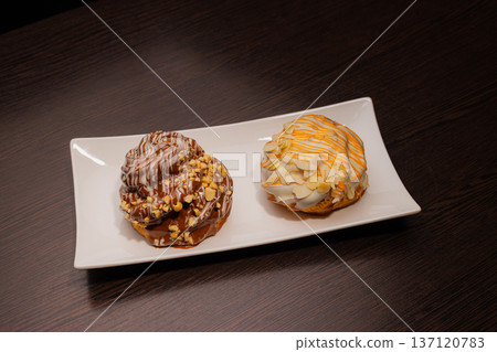 Cinnabon on a white plate and on a wooden table Cinnabon on a white plate and on a wooden table 137120783