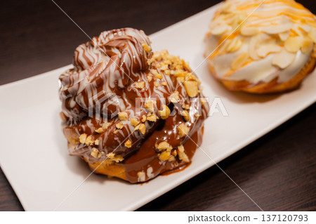Cinnabon on a white plate and on a wooden table 137120793