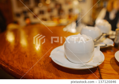 The sugar bowl stands on a wooden table The sugar bowl stands on a wooden table 137120846