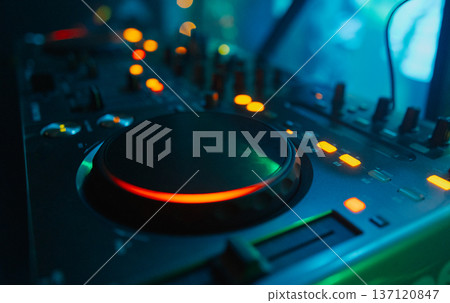 A DJ booth in the evening lights of a club A DJ booth in the evening lights of a club 137120847