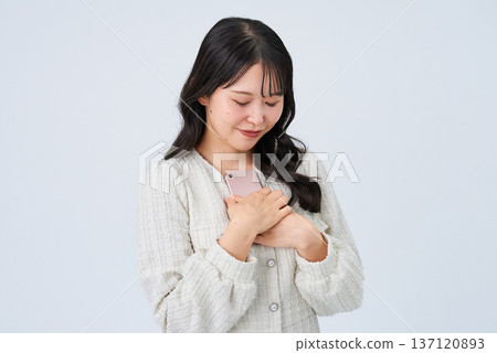 Smiling young woman holding a smartphone Smiling young woman holding a smartphone 137120893