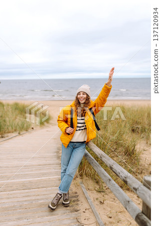 Attractive woman on a windy cold beach. Travel, nature concept. 137120934
