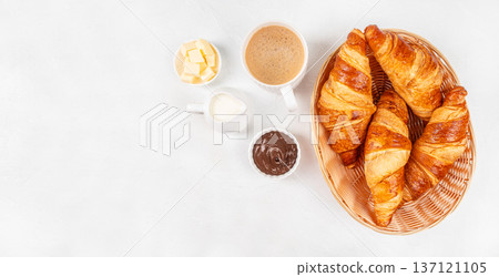 Top View Croissants Basket with Chocolate Spread, Butter and Coffee on White Background 137121105