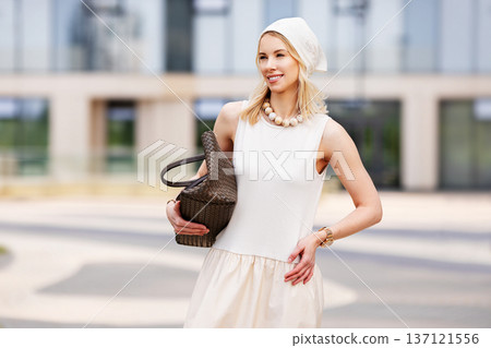 Portrait beautiful young blonde woman model smiling outdoors in urban location. Fashionable female wearing beige summer outfit and accessories, light look, modern city lifestyle, elegance, confidence 137121556