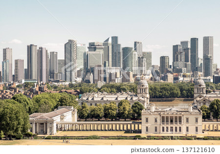 the iconic Queen's House and the Old Royal Naval College in the foreground, with the modern skyscrapers of Canary Wharf forming the distinctive skyline in the background. the iconic Queen's House and the Old Royal Naval College in the foreground, with the modern skyscrapers of Canary Wharf forming the distinctive skyline in the background. 137121610