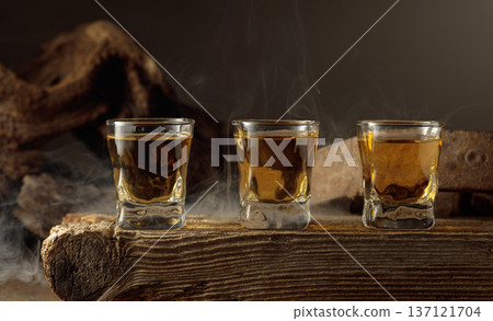 Whiskey shots on a old wooden board. 137121704