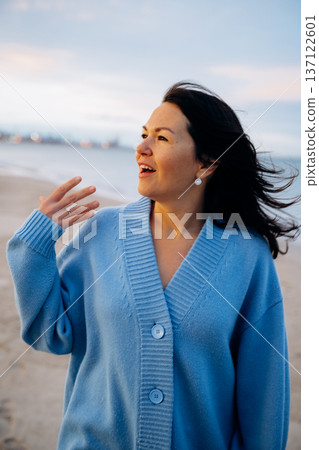 Woman Enjoying Sea Breeze with Wind in Hair Woman Enjoying Sea Breeze with Wind in Hair 137122601