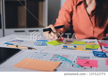team of UI UX web designer are working together to develop mobile responsive websites with UI UX front end designer previews 137122773