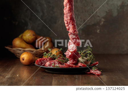 Dry-cured sausages with thyme and pears. Dry-cured sausages with thyme and pears. 137124025