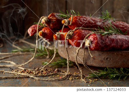 Smoked and dry cured sausages on a rustic background. 137124033