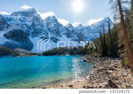 Moraine Lake and the reflection of the snow-capped Ten Peaks on a sunny autumn morning in Banff National Park Moraine Lake and the reflection of the snow-capped Ten Peaks on a sunny autumn morning in Banff National Park 137124172