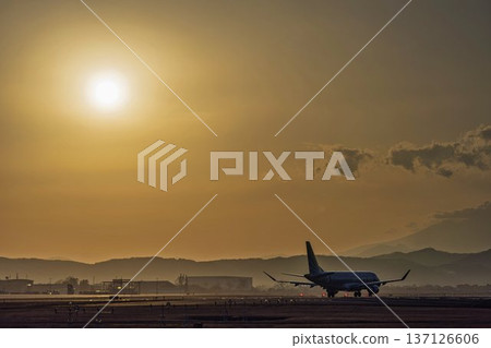 Sendai Airport at dusk: Sunset and taxiing planes, Natori City, Miyagi Prefecture Sendai Airport at dusk: Sunset and taxiing planes, Natori City, Miyagi Prefecture 137126606