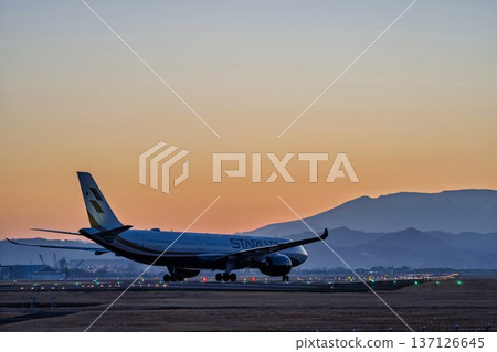Sendai Airport at dusk, plane taxiing, Natori City, Miyagi Prefecture 137126645