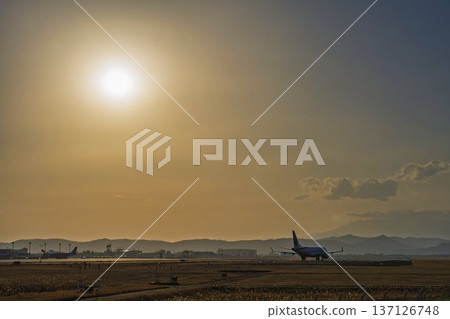 Sendai Airport at dusk: Sunset and planes taking off, Natori City, Miyagi Prefecture Sendai Airport at dusk: Sunset and planes taking off, Natori City, Miyagi Prefecture 137126748