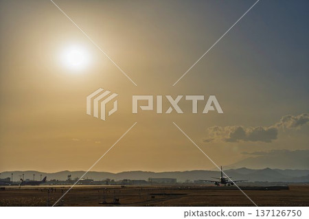 Sendai Airport at dusk: Sunset and planes taking off, Natori City, Miyagi Prefecture Sendai Airport at dusk: Sunset and planes taking off, Natori City, Miyagi Prefecture 137126750